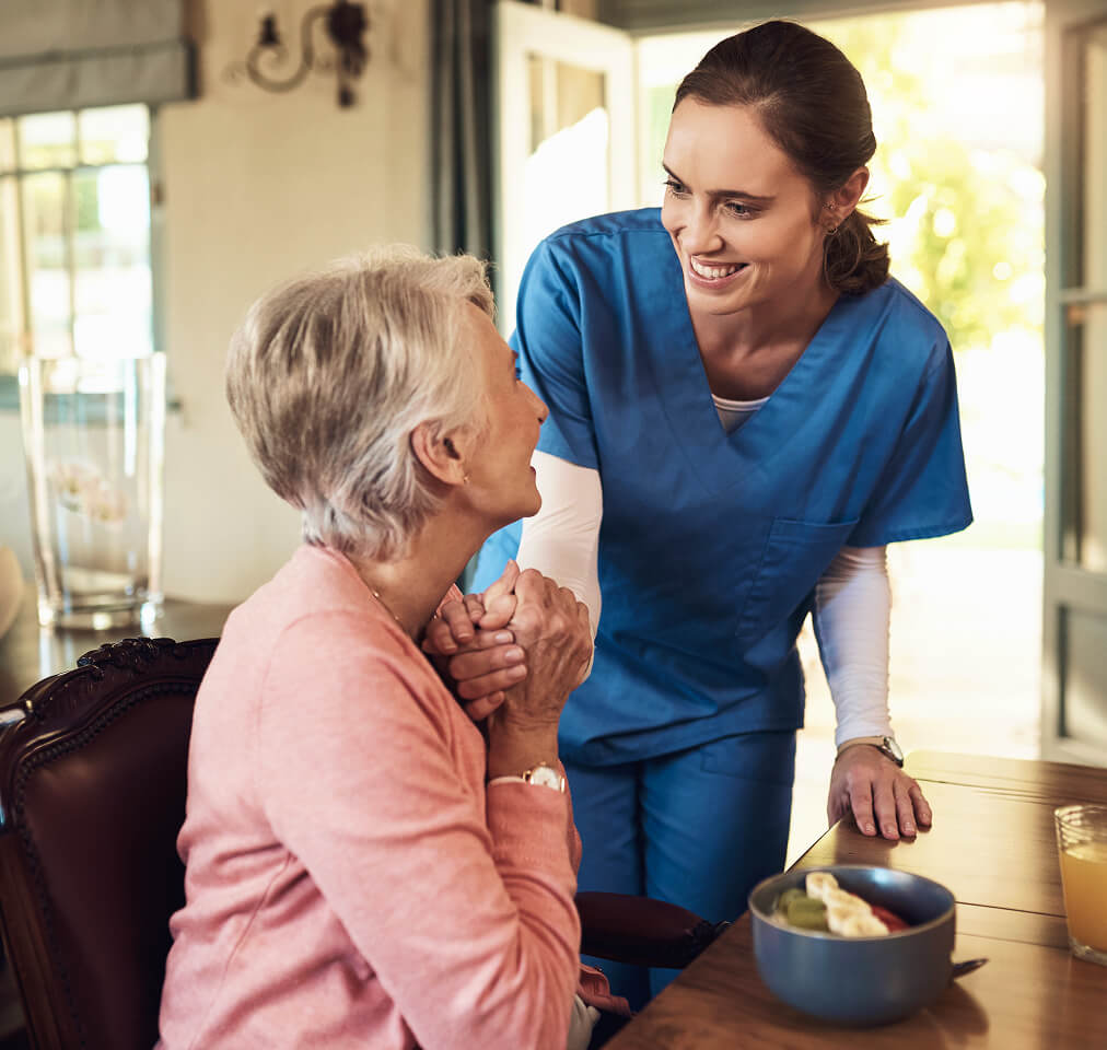 Caregiver helping a senior with daily activities at home