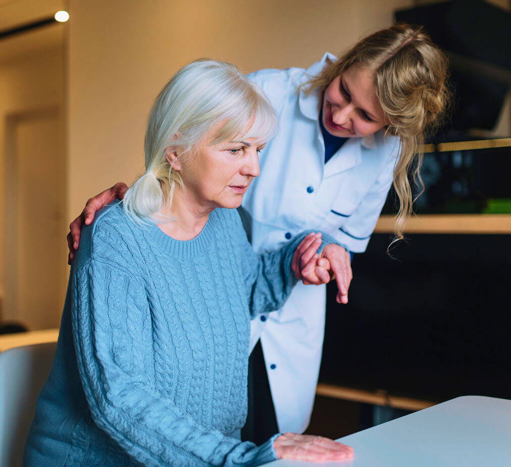 Senior woman receiving care from a friendly caregiver